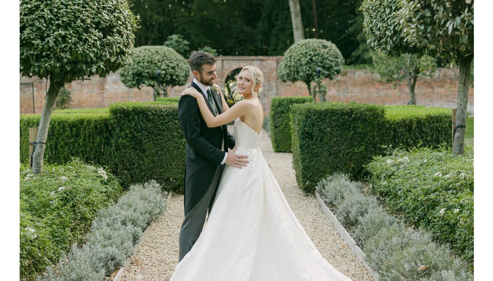 Bride and groom in picturesque Hampshire country garden.