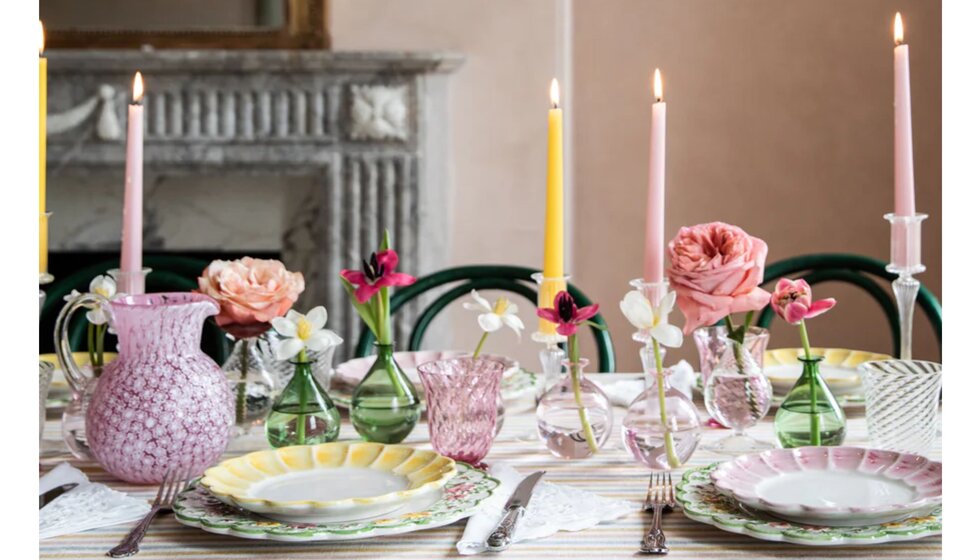 Pastel yellow and pink Skye McAlpine tableware and glassware wedding presents, adorn a beautifully set table with candles.