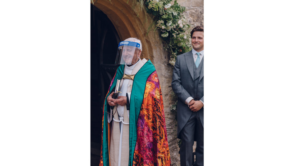 The vicar wearing a COVID secure visor during the Church ceremony.
