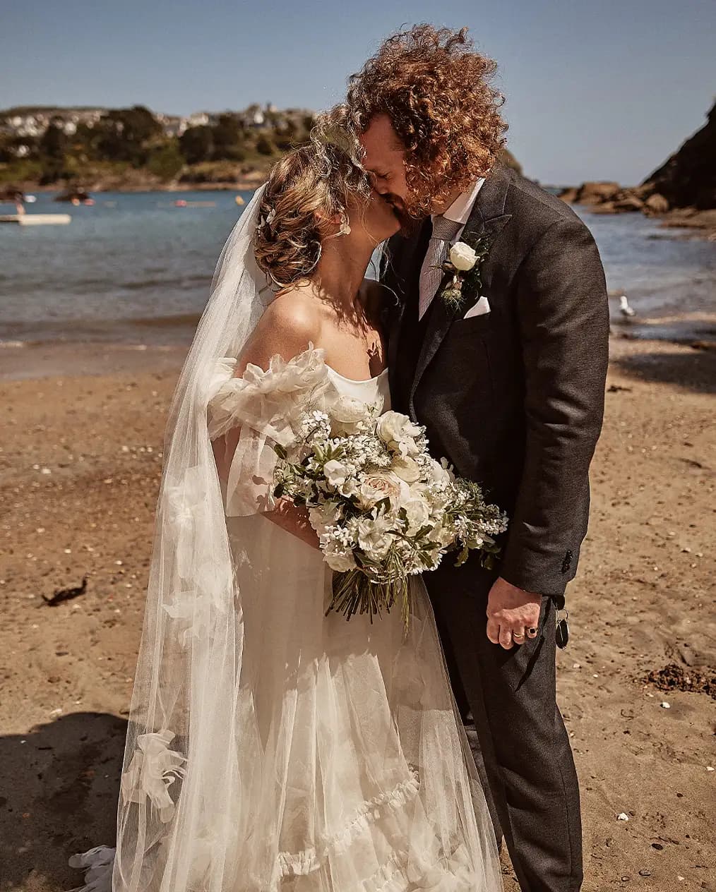 bride and groom together sunny Cornwall beach wedding