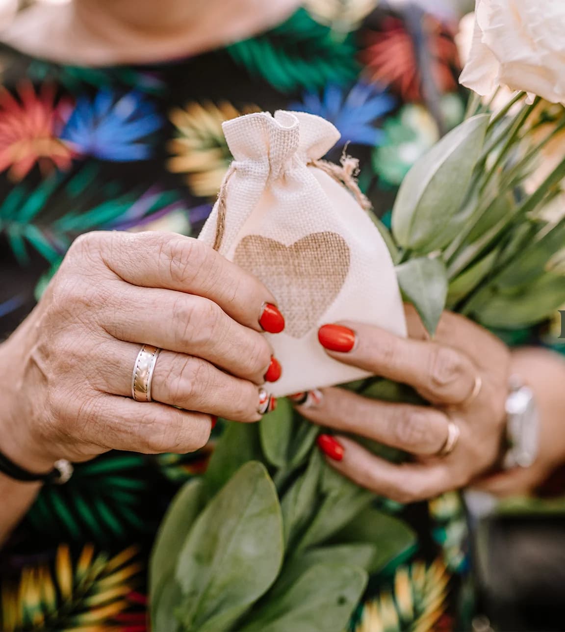 A wedding guests holds a wedding favour, a small bag with flower seeds