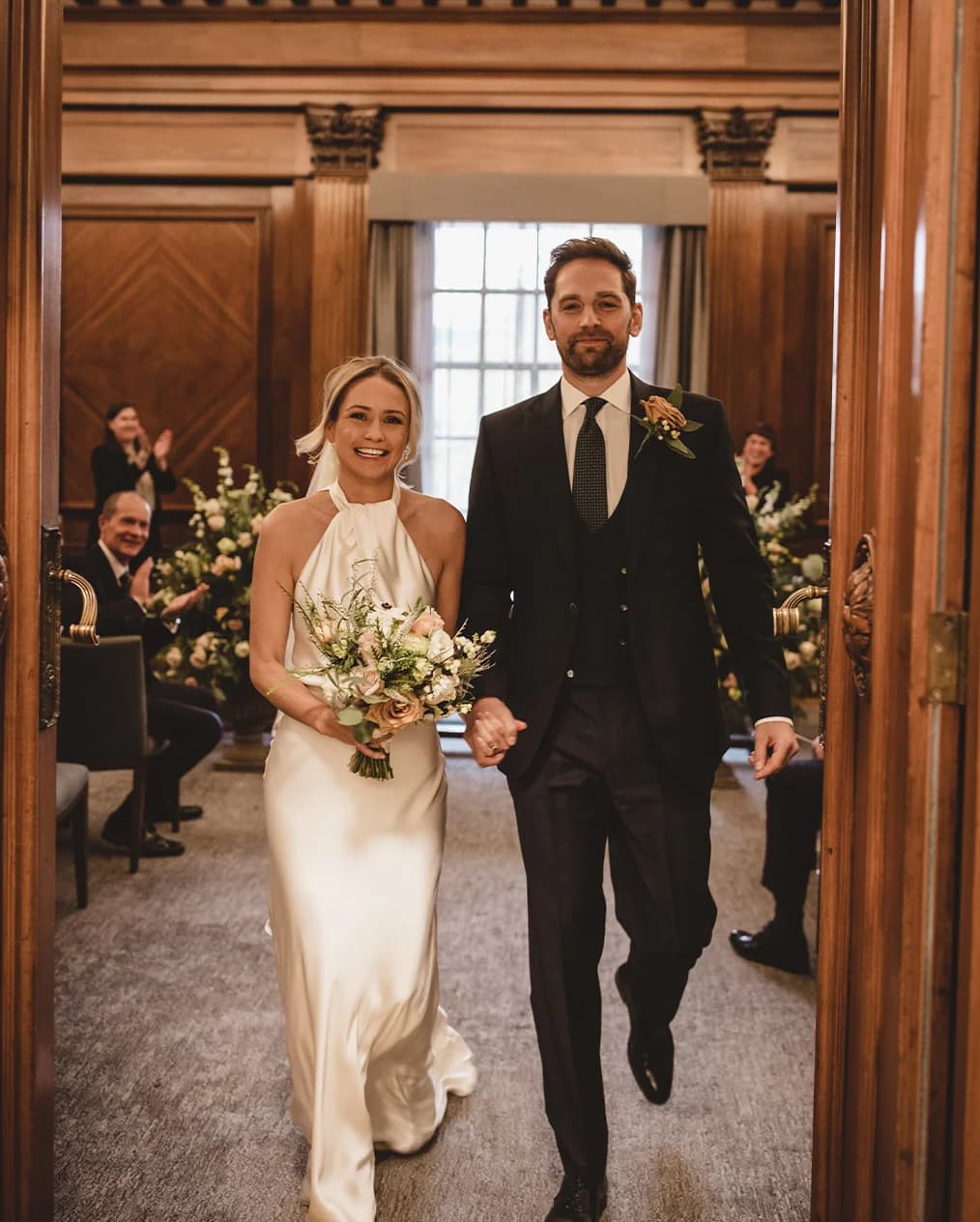 Husband and wife walking out of their ceremony having just gotten married