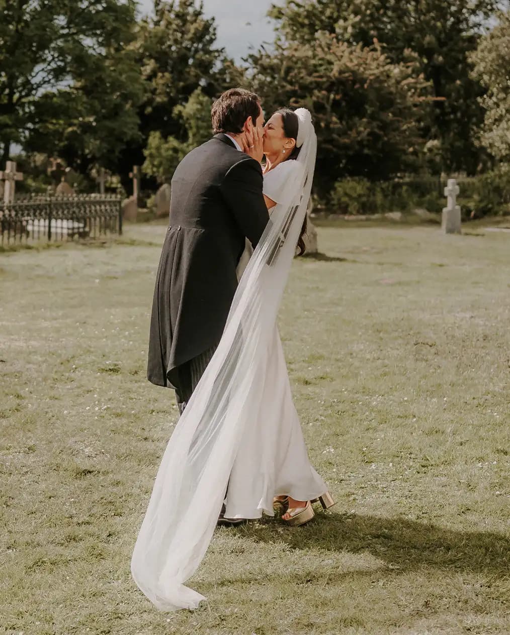 bride and groom sharing a romantic kiss together