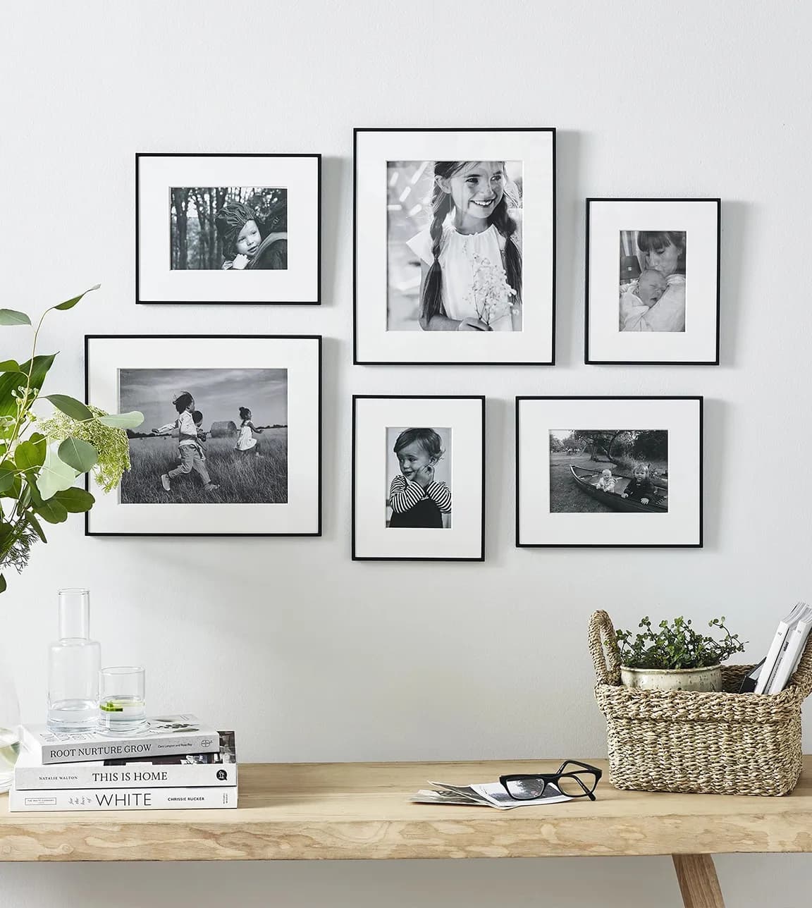 A gallery wall features a mix of the same frames in different sizes.