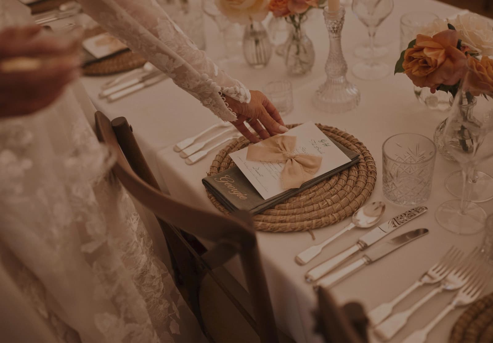 Bride touches wedding menu card with wedding catering options created by Doggart & Squash