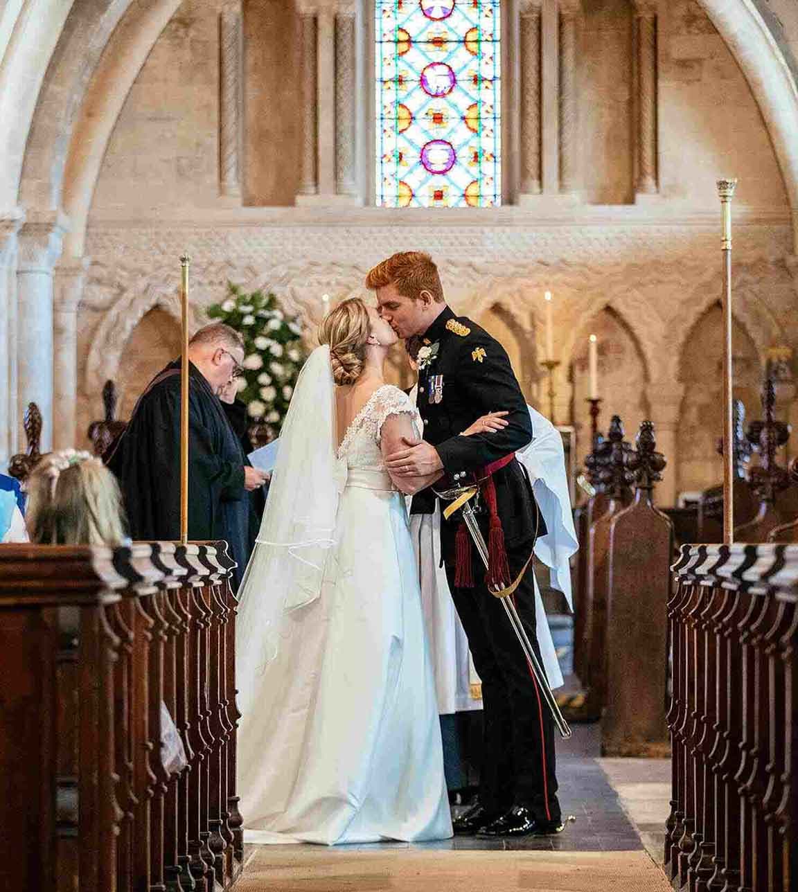 Husband and wife kissing at the altar