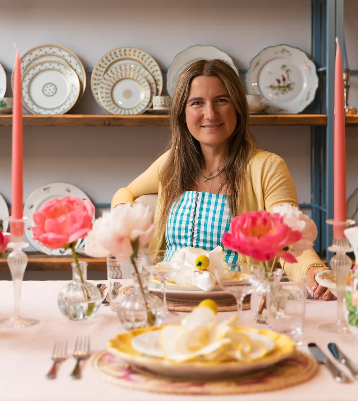 Skye McAlpine sits behind the table with Italian inspired tablescape in the Wedding Presents Company