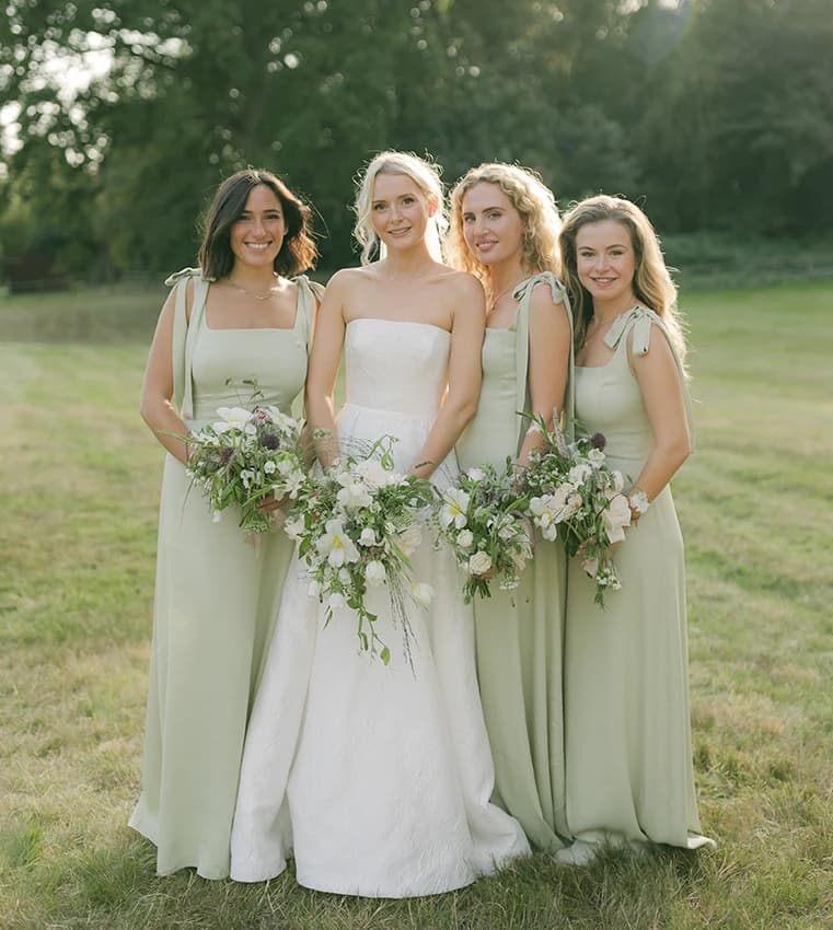 Bride and bridesmaids in sage green dresses from Maids to Measure