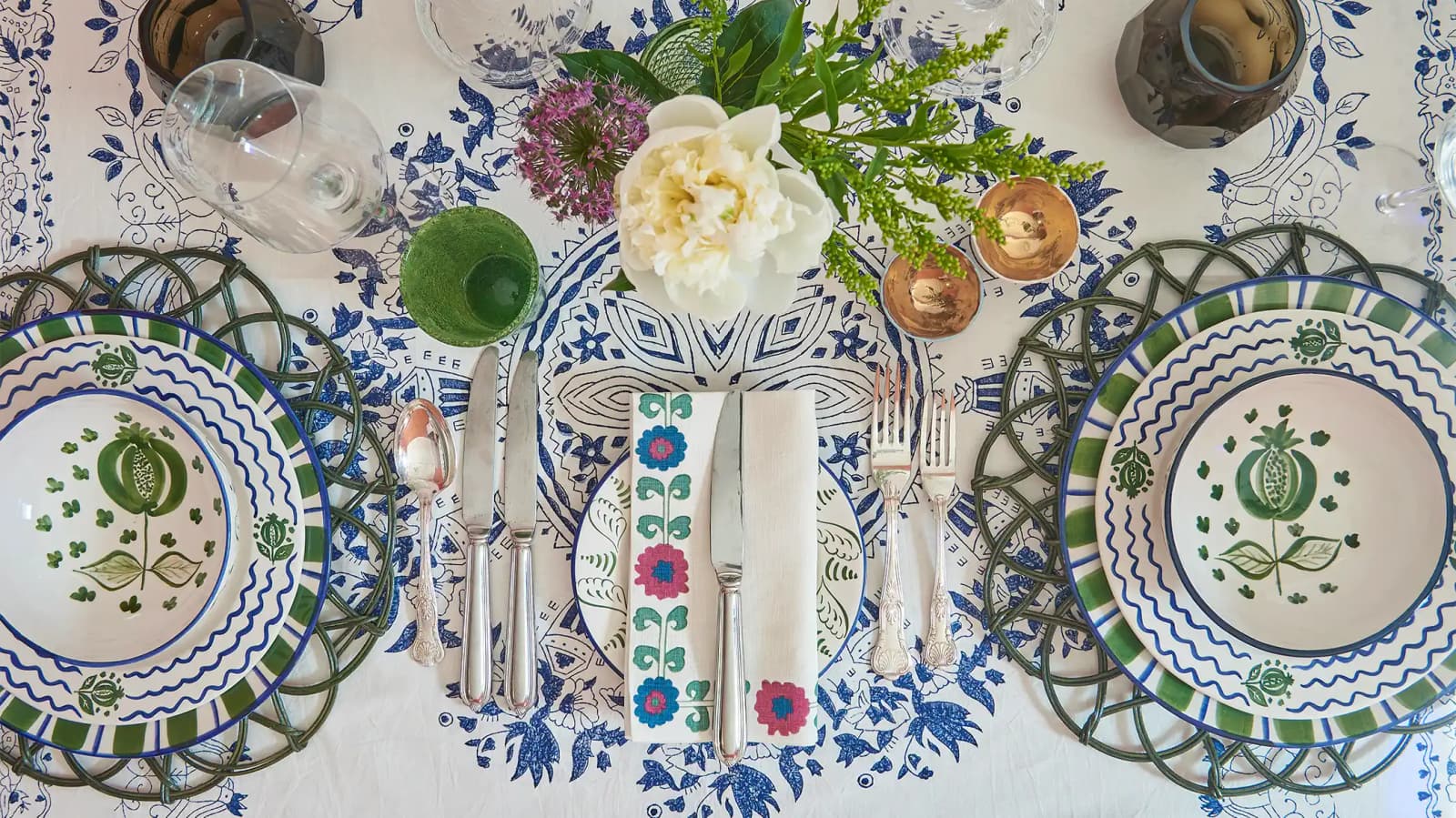 A flatlay of a blue tablescape featuring electic mix of Penny Morrison tableware designs