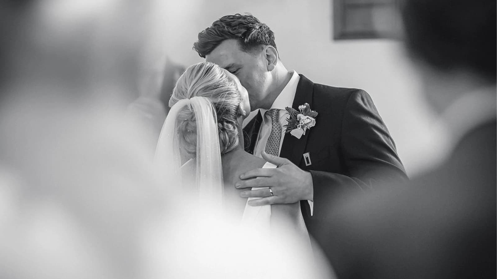 bride and groom sharing a romantic kiss