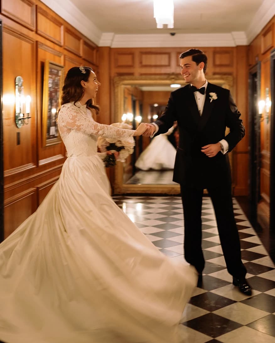 Bride and groom dance together at the hall with checkerboard floor at The Ned hotel.