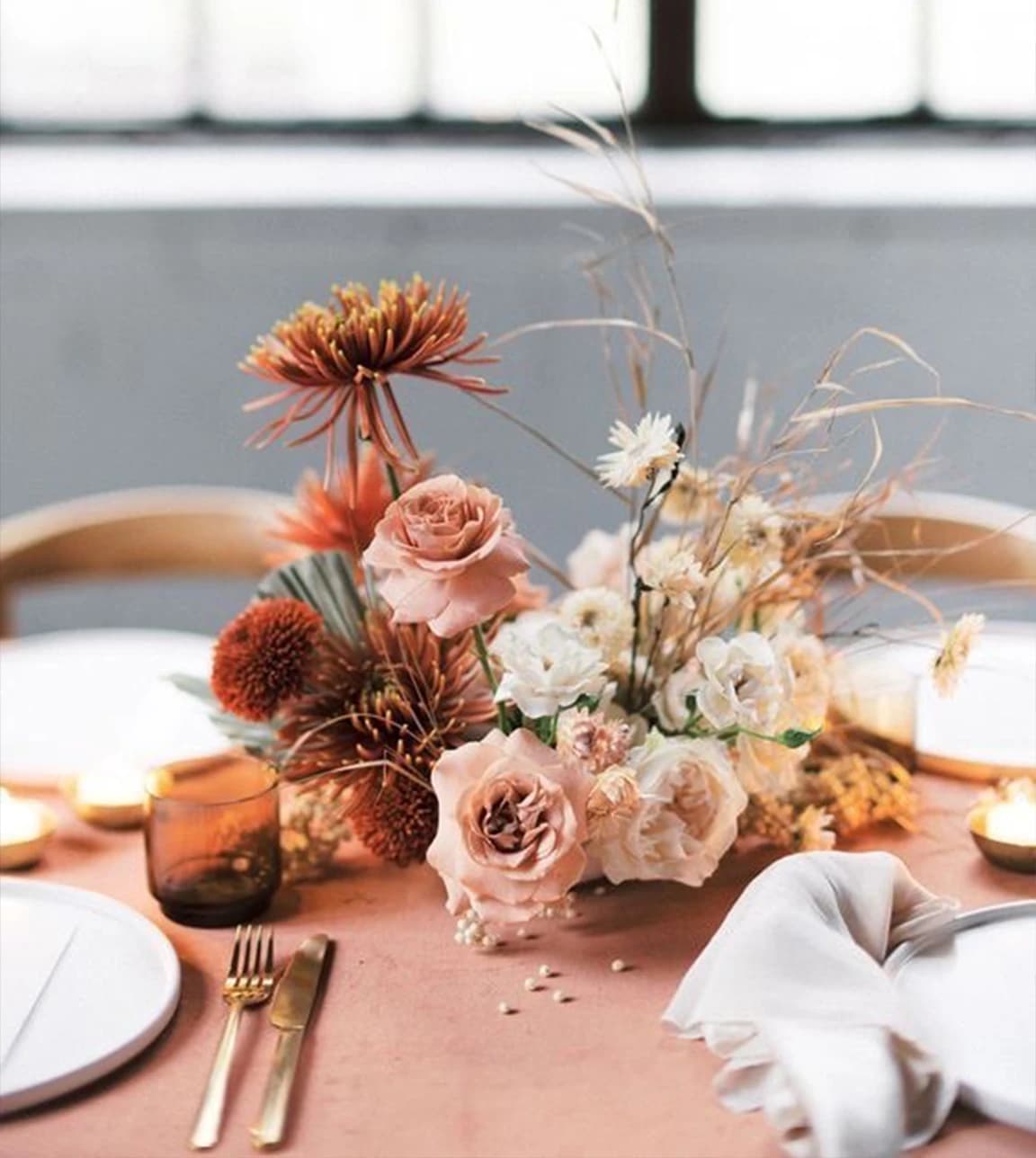 An autumn wedding flower bouquet placed on themed wedding table.