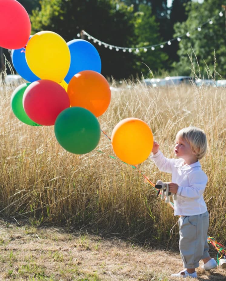 Kid playing with balloons on wedding day