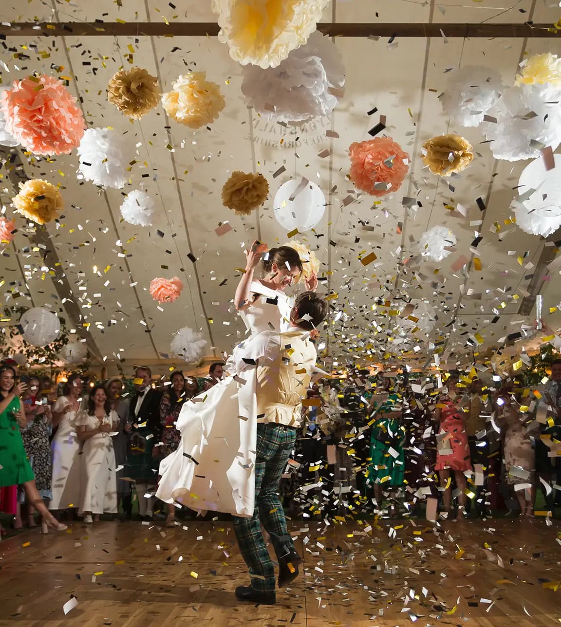 Bride and groom celebrate their first dance with confetti.