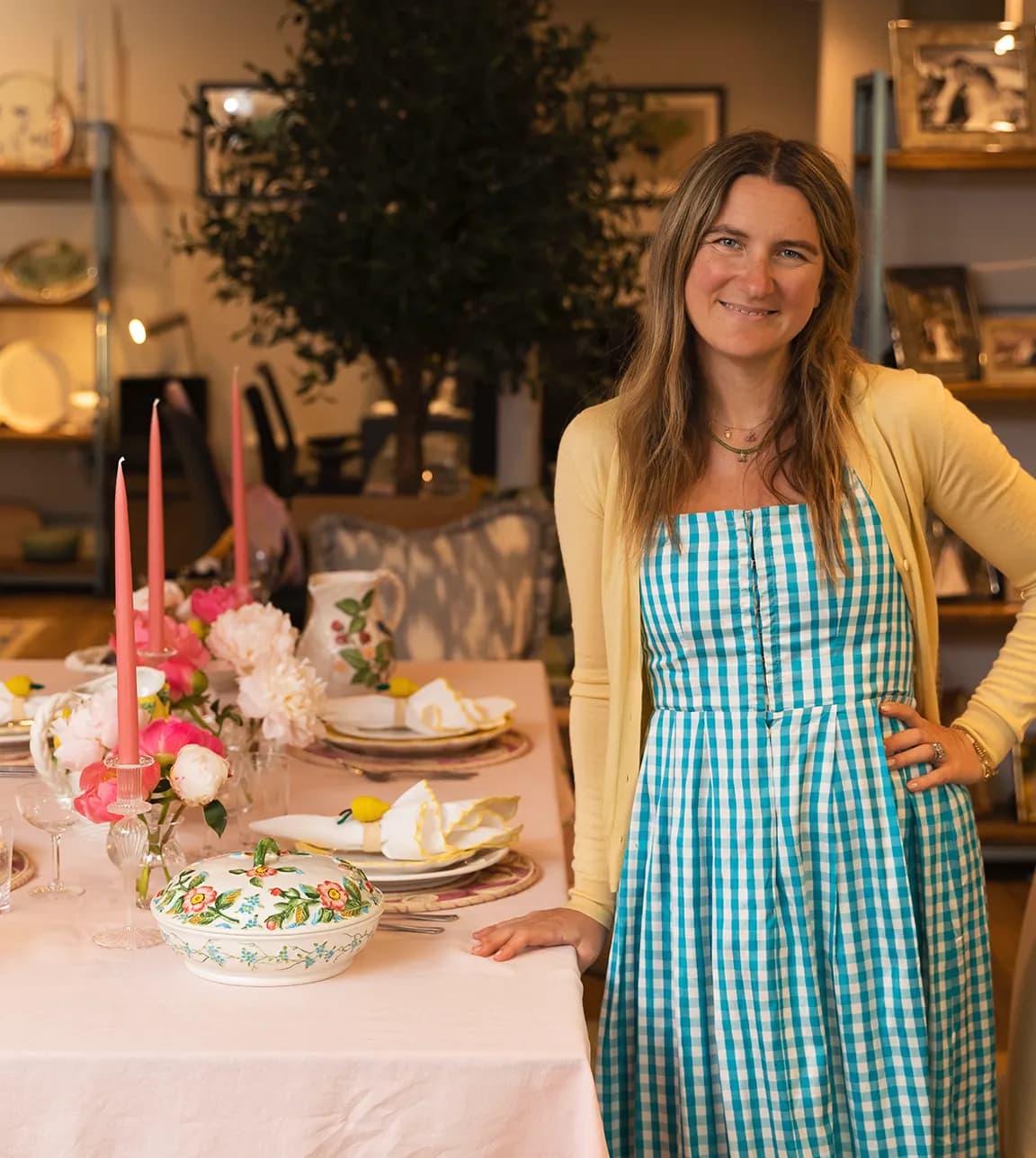 Skye McAlpine stands next to a table with Italian inspired tablescape in The Wedding Present Company Showroom