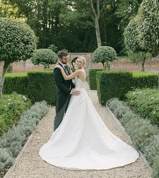 Bride and groom pose in a beautiful English garden in Hampshire