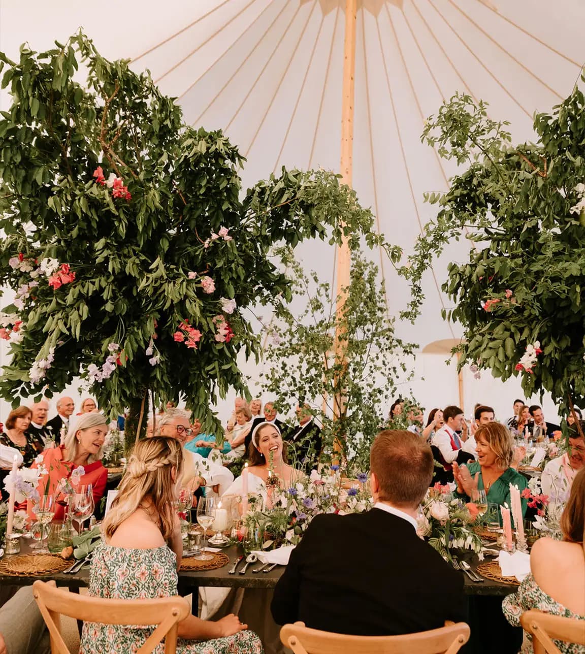 Guests and newlyweds sitting in a marquee during their wedding dinner