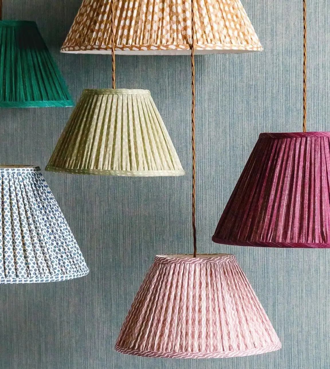 Multi-coloured Fermoie lampshades hang from the top