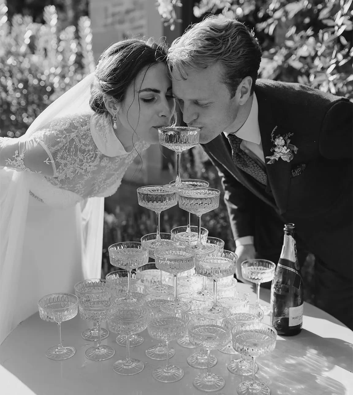 Bride and groom drink from the champagne tower during their wedding drink reception