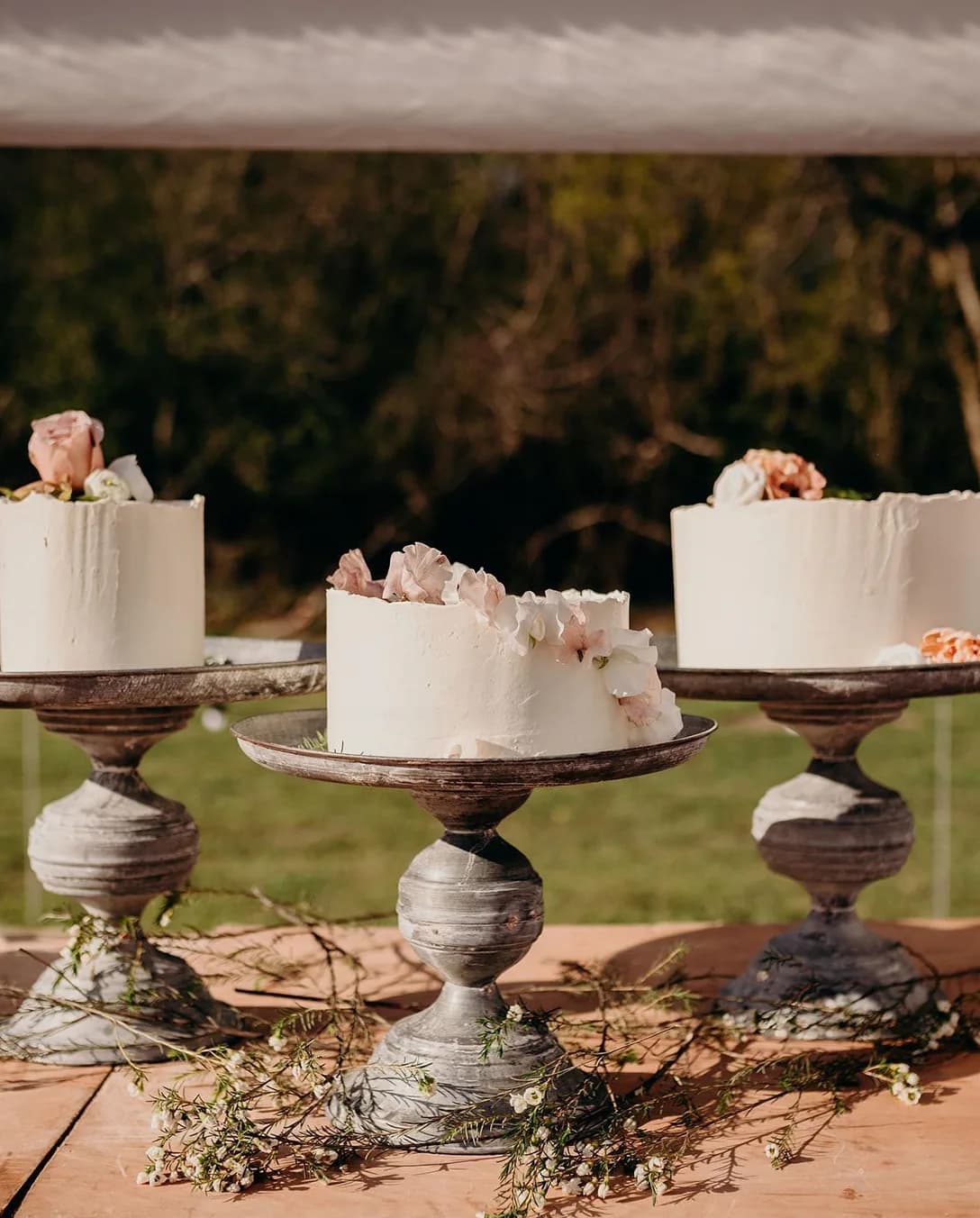 Wedding catering with buttercream cakes decorated with pastel flowers.