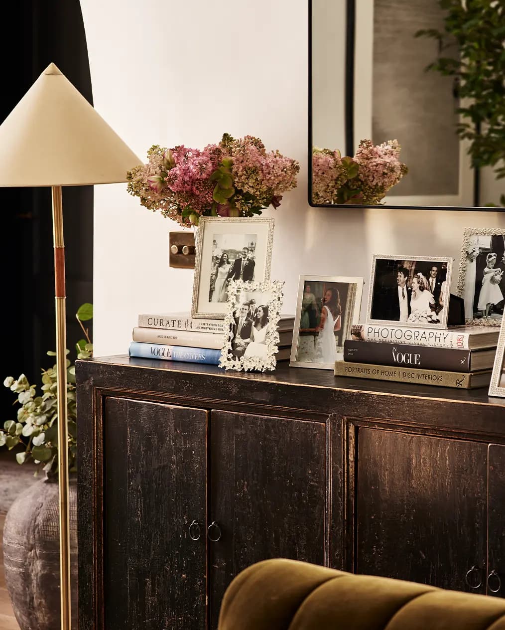 A console with wedding photos in Addison Ross enamel photo frames