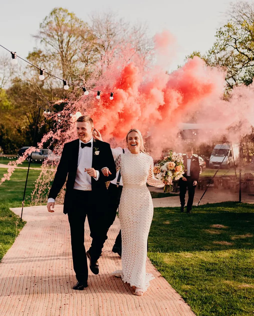 bride and groom wedding aisle pink smoke