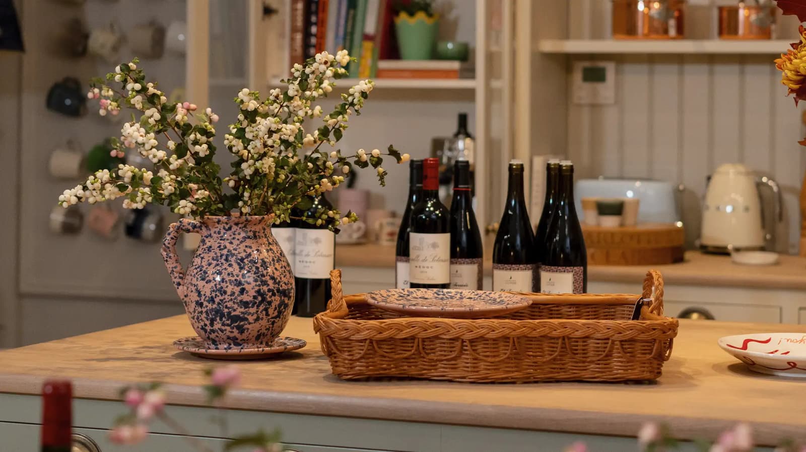 Wine bottles for the dinner party are arranged on a kitchen counter in The Wedding Present Company showroom