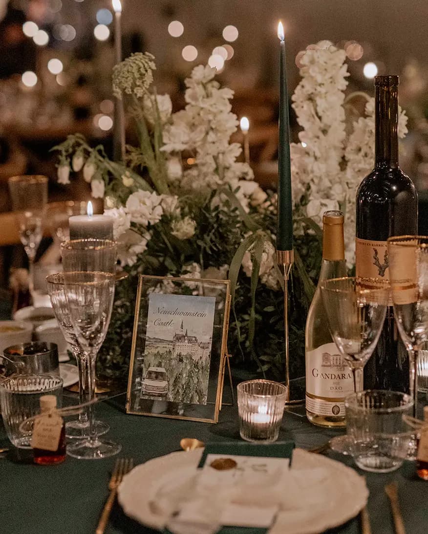 A luxury illustrated wedding seating sign is placed next to an elegant wedding table decor