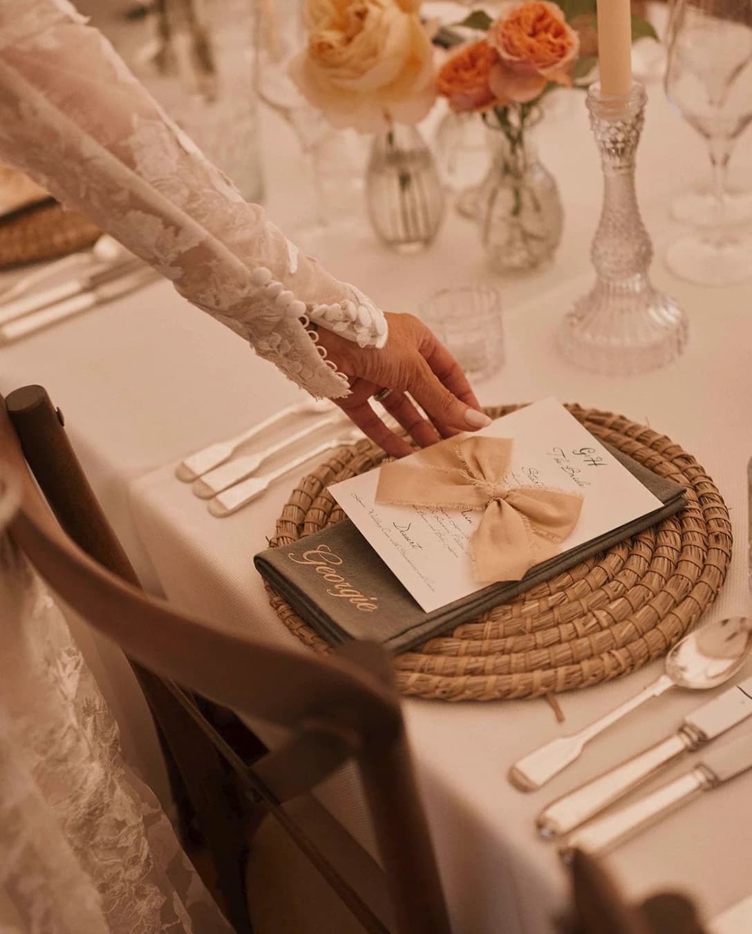 Bride touches wedding menu card with wedding catering options created by Doggart & Squash