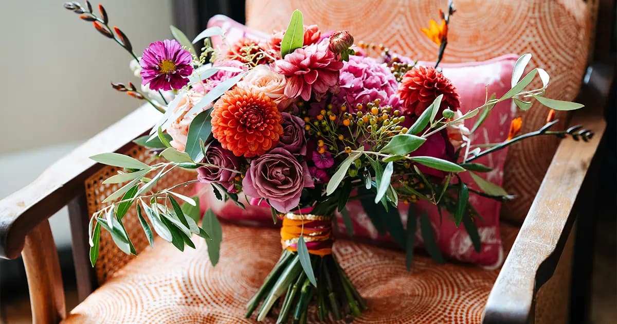 Bunch of wedding flowers featuring pink and orange blooms