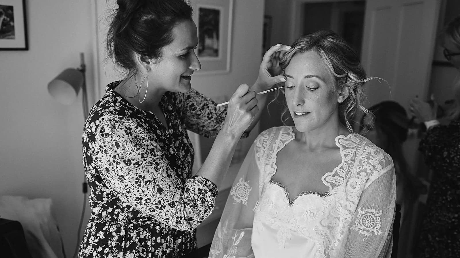 bride getting her hair and makeup done stylist