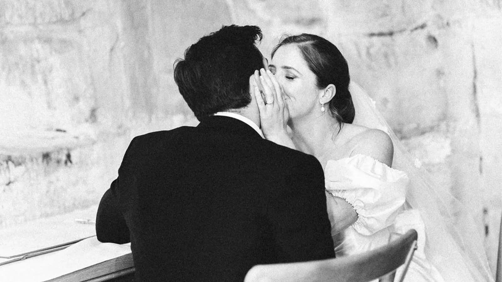 bride and groom kissing wedding celebration