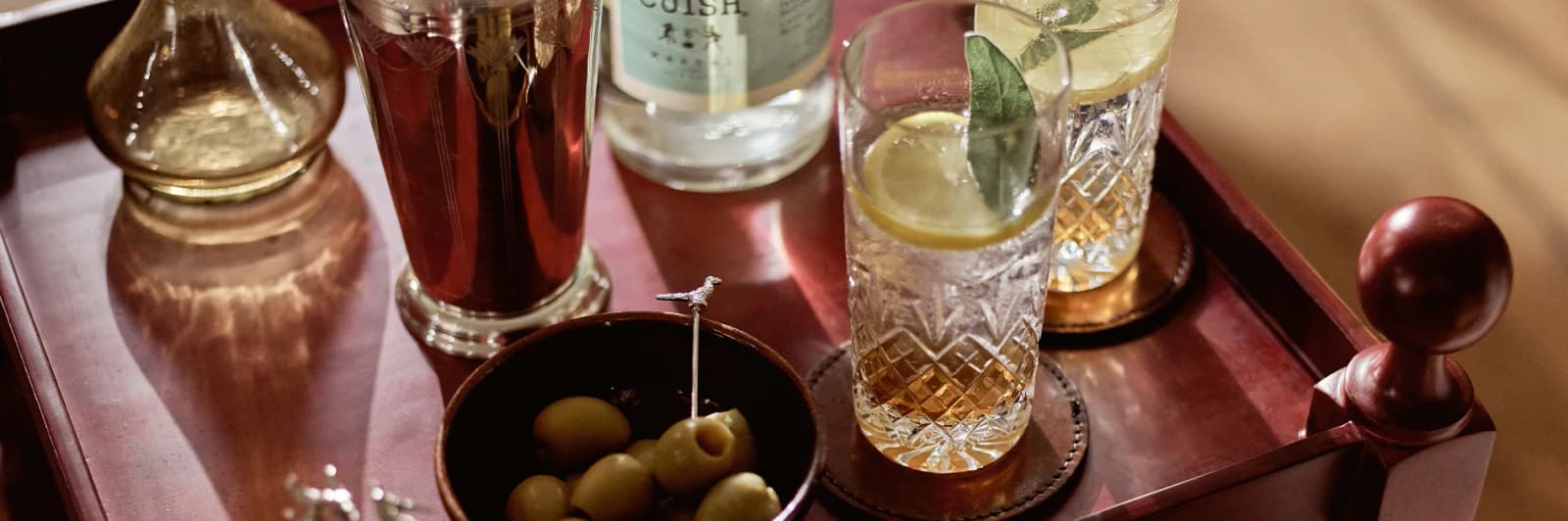 Mix of cocktails and nibbles on side table