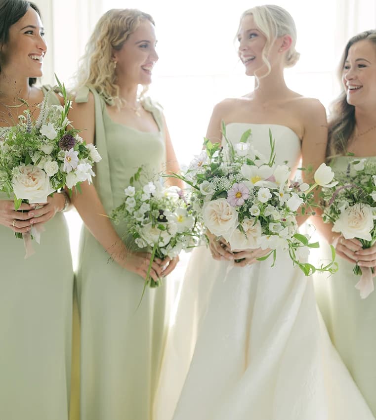 Bride and a bridesmaid holding English garden inspired, seasonal bouquet