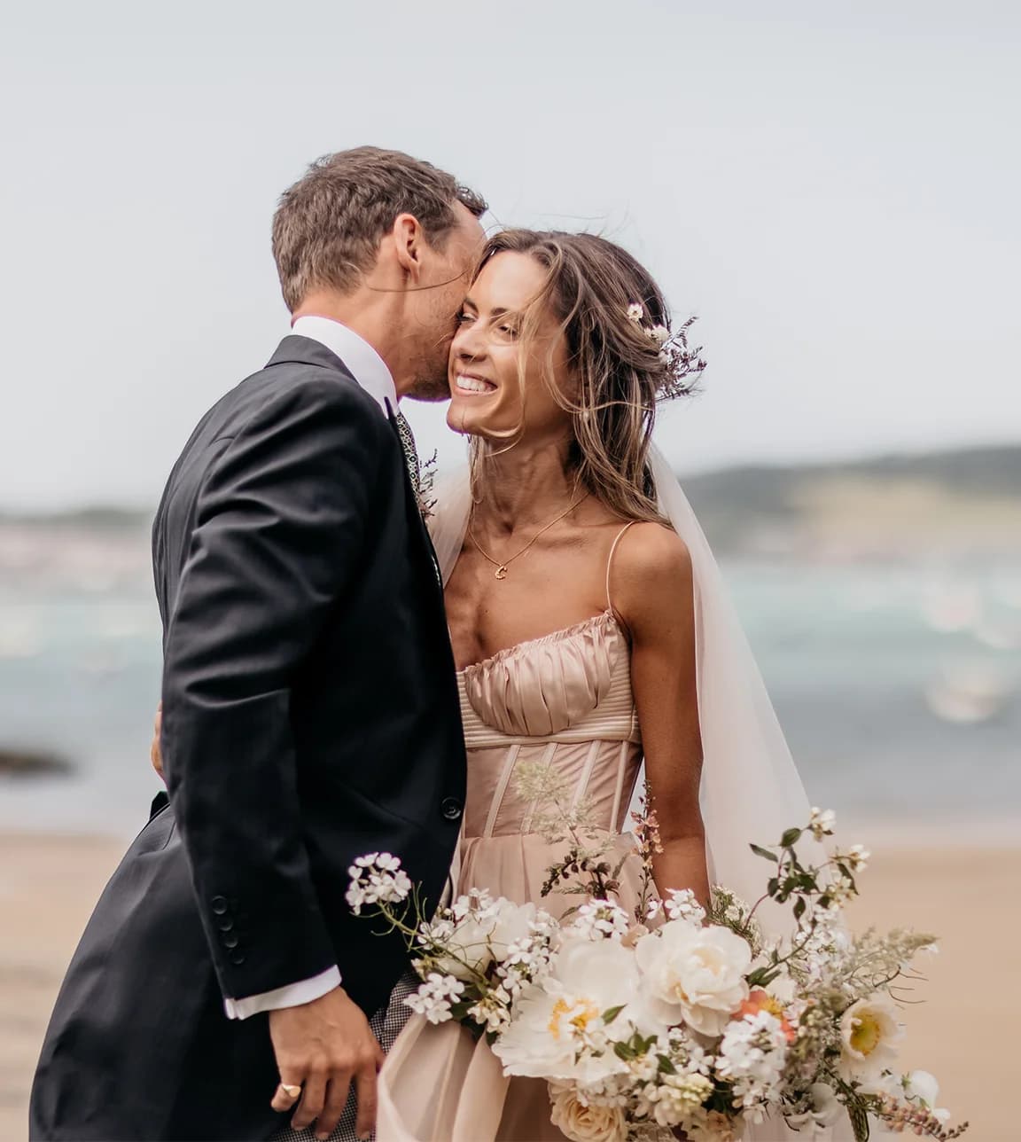 bride and groom with their stunning wedding flowers