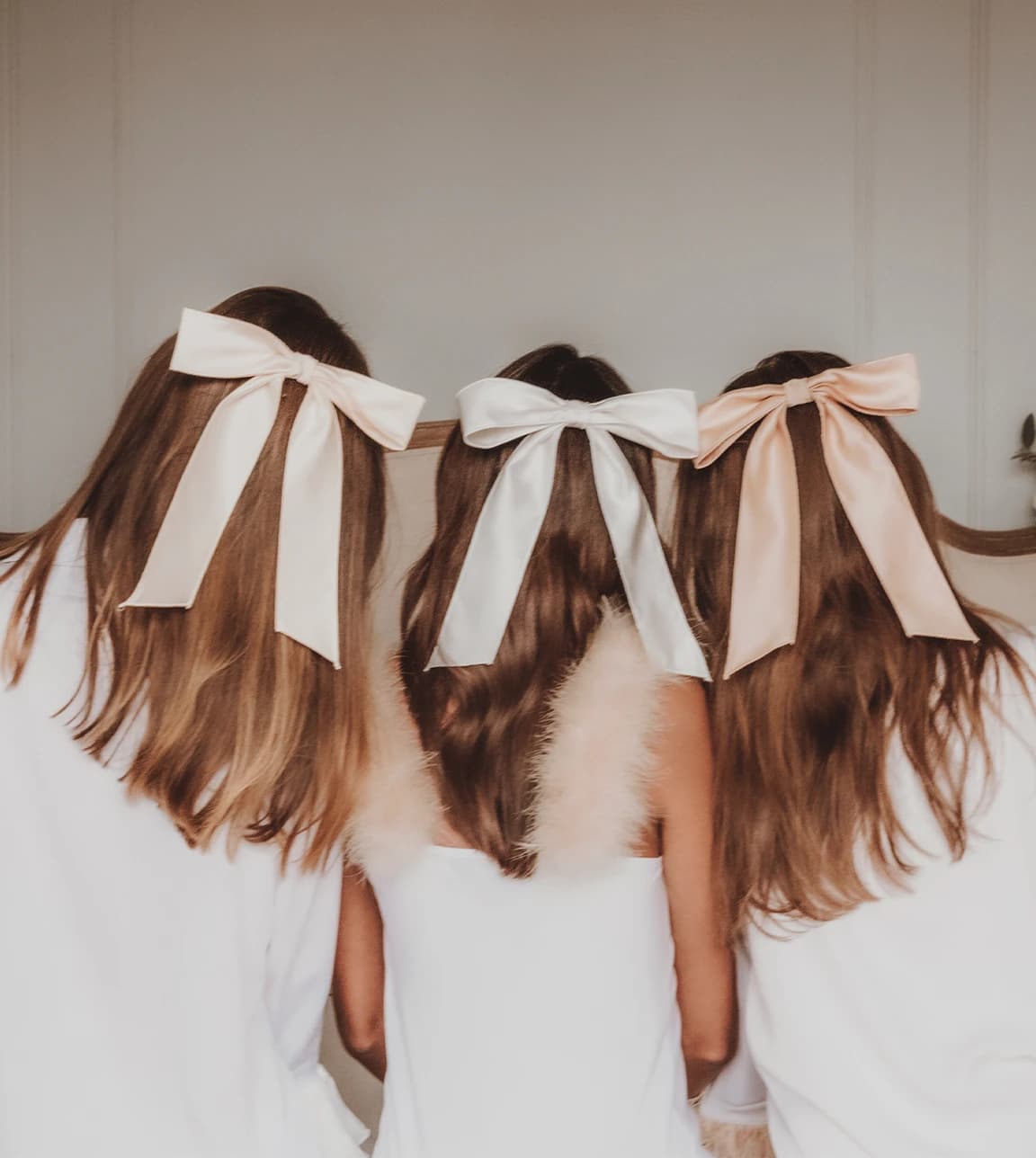 A bridal party with matching light pink hair bows from Gigi and Olive brand. 