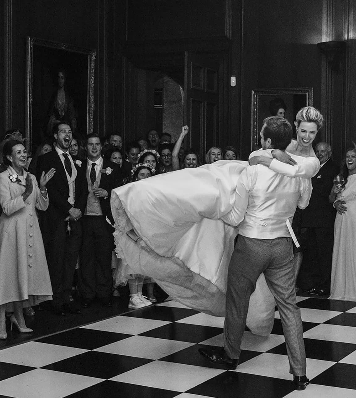 Groom holds the bride during their traditional first dance.