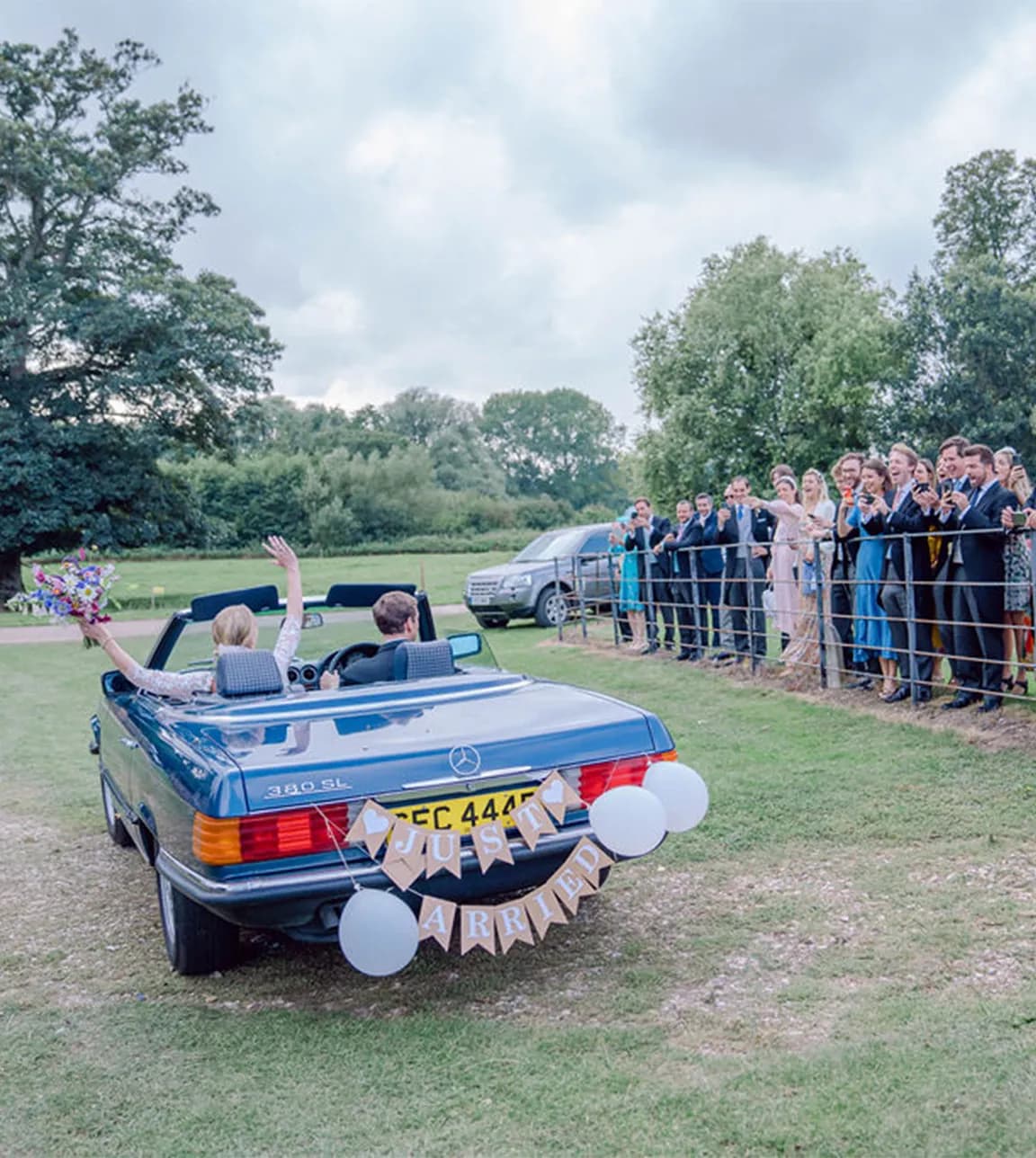 bride and groom driving just married wedding car