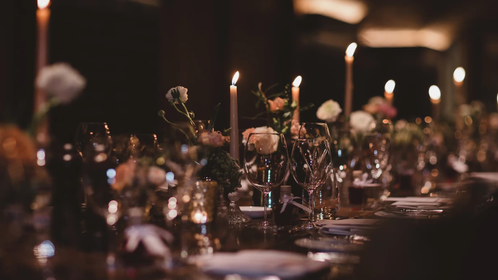 Wedding reception tablescape in wine cellar with candles