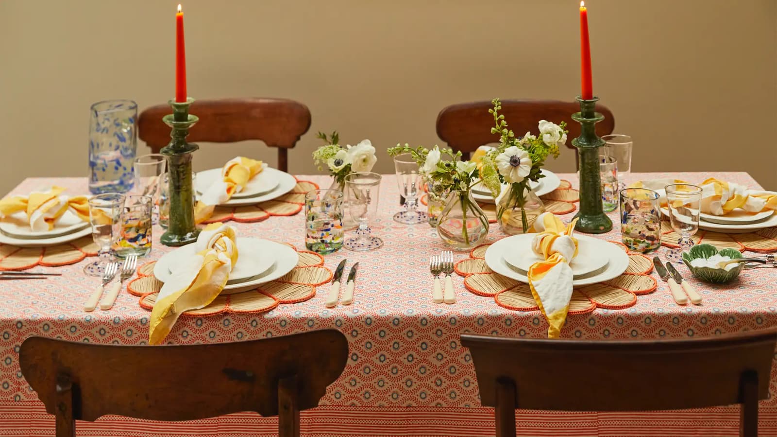 Orange coloured tablescape featuring Rosalyn's wedding presents: crockery, flower vase, striped napkins and terazzo glass tumblers.