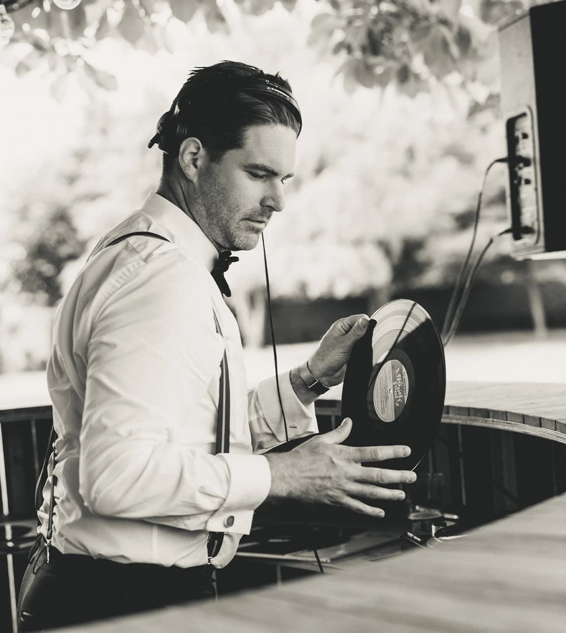 wedding DJ wearing a bow tie spinning vintage records