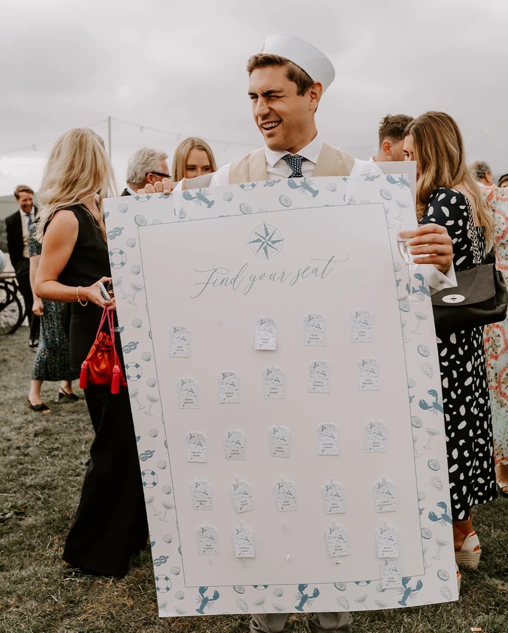 ushers with guests table names on fun reception drinks