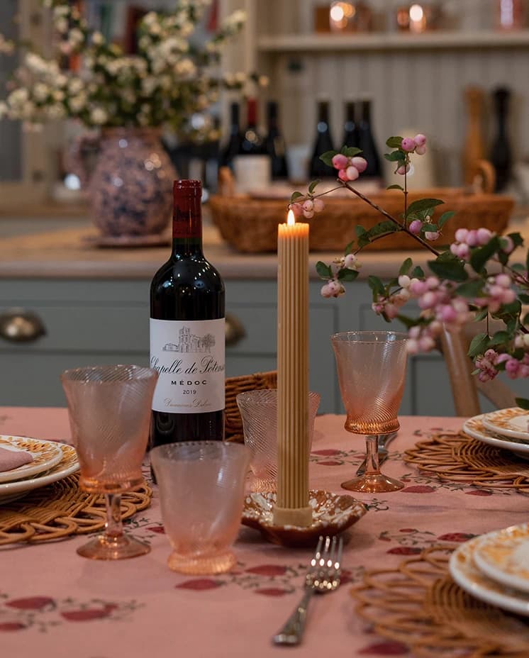 Wine bottle with coloured glassware wedding gifts beautifully arranged on a table in The Wedding Present Company showroom