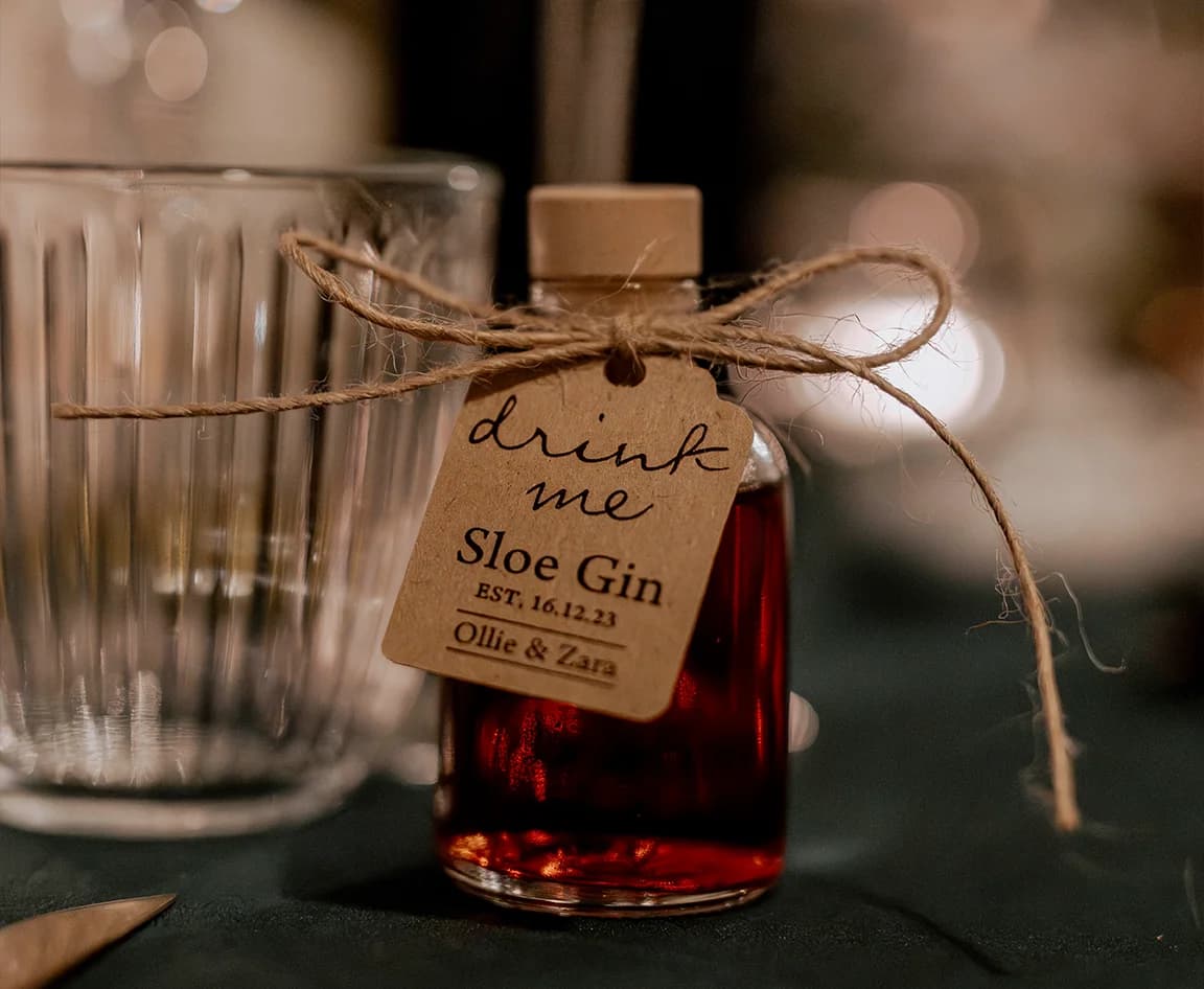 A little bottle of homemade gin with tag 'Drink Me'