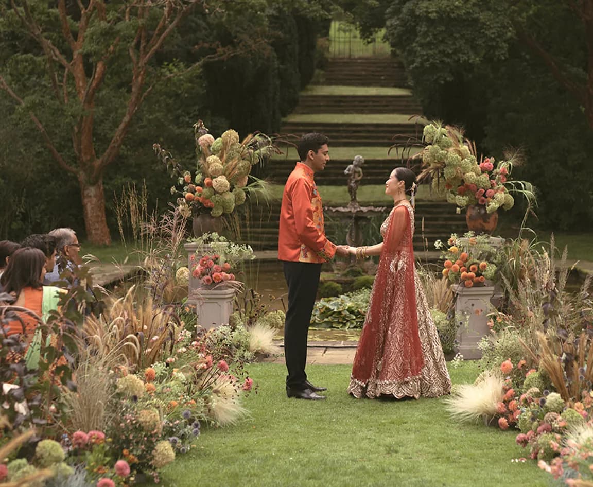 Bride and groom during their fusion wedding ceremony at exclusive-use exterior wedding venue