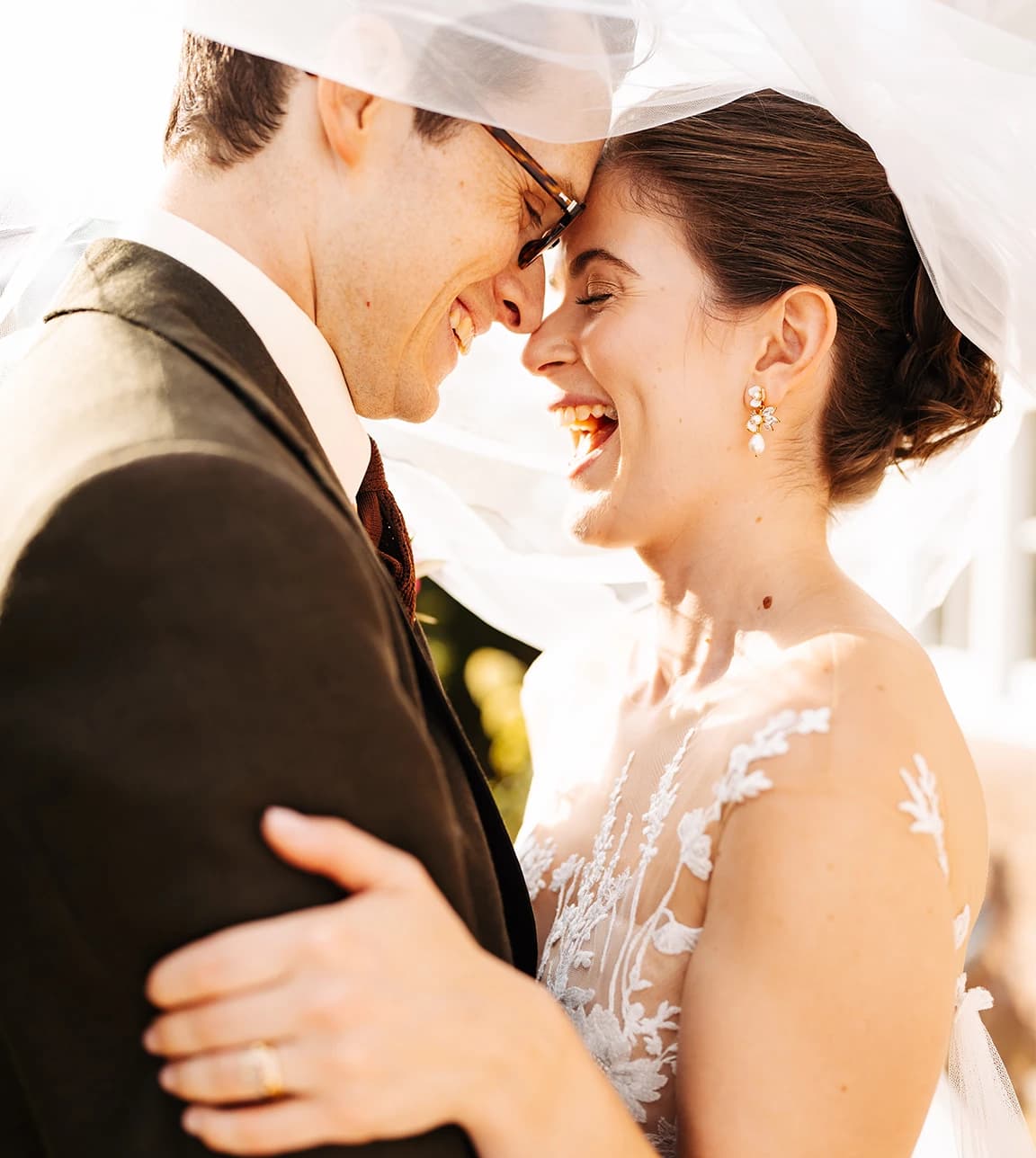 Happy bride and groom are captured in joyous moment, holding each other close