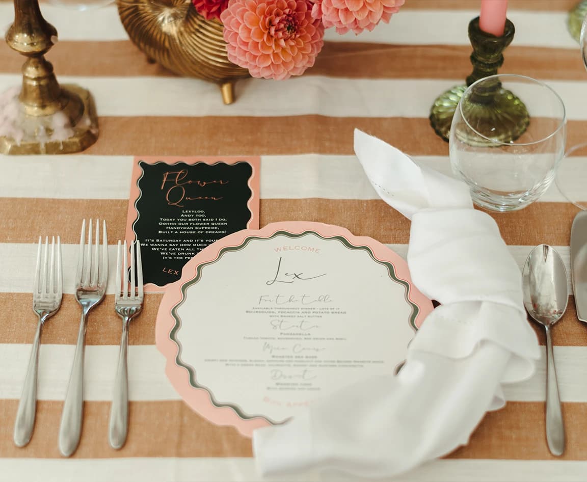 Round wedding catering menu card is placed on beautifully decorated table with vintage tableware.