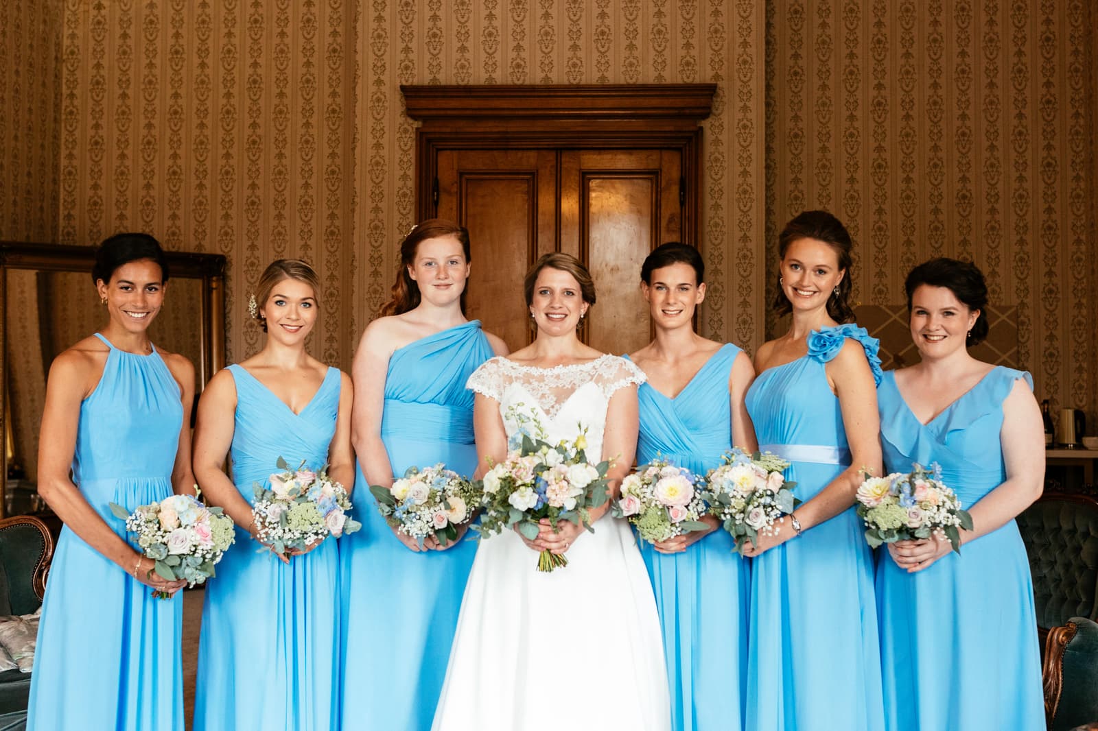 Bridesmaids and a bride wearing dresses 
