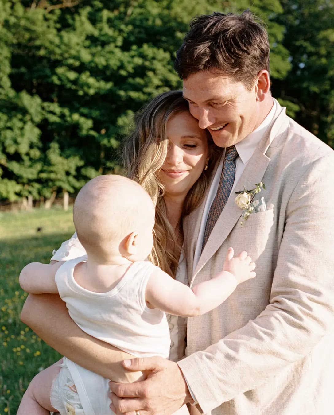 bride and groom with their cute baby