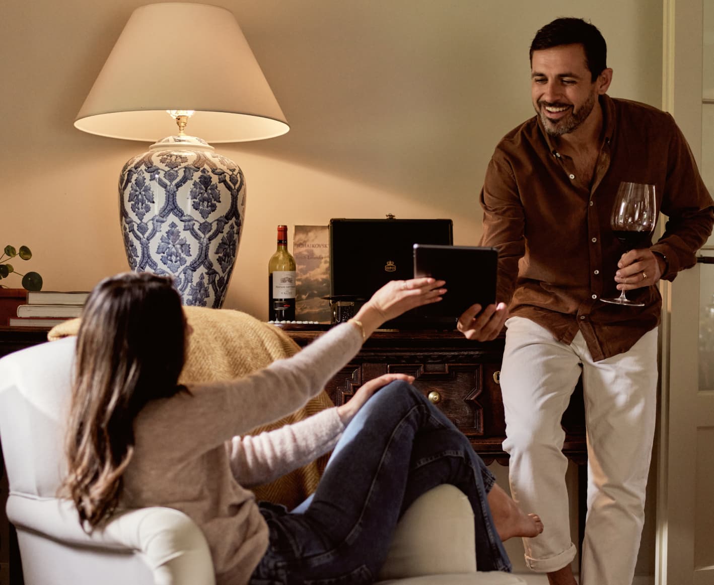 Married couple drinking wine in their living room 